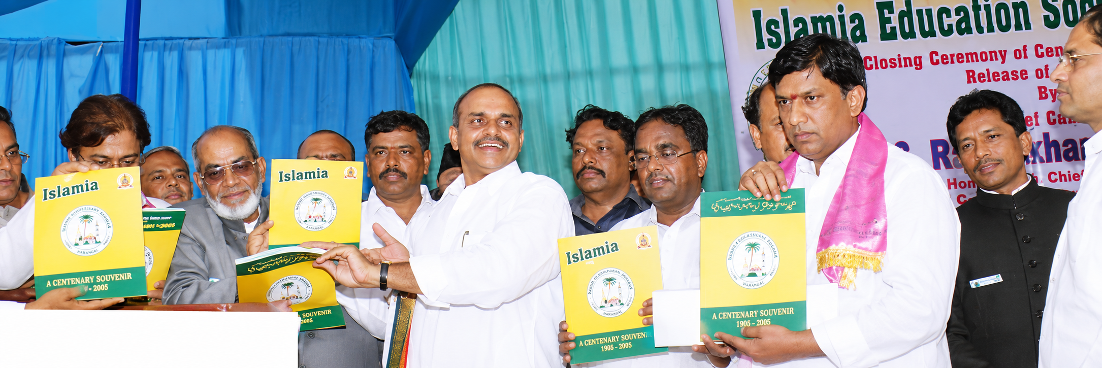 Guests holding copies of the Islamia souvenir at the release ceremony